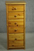 A late 20th century pine tall slender chest, of five drawers with knob handles. H.108 W.44 D.39cm.