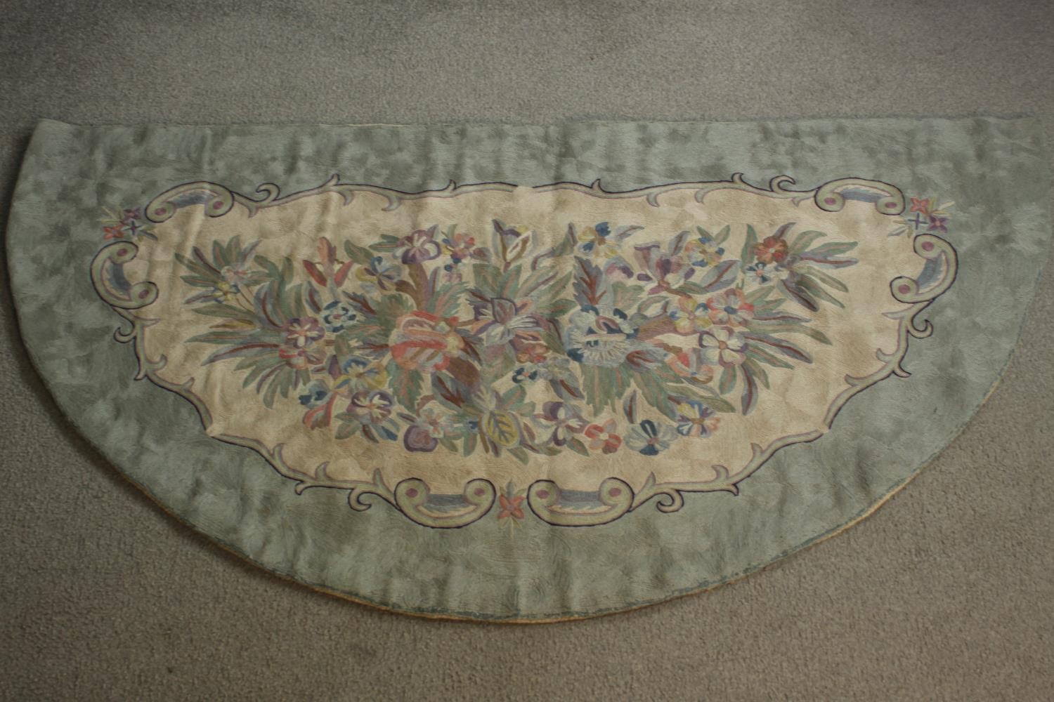 A half moon Inidan chain stitch rug with floral design. L.144 W.77cm
