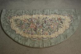 A half moon Inidan chain stitch rug with floral design. L.144 W.77cm
