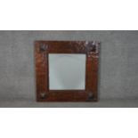 An Eastern teak square wall mirror, with a bevelled mirror plate in a rustic frame. H.80 W.80cm