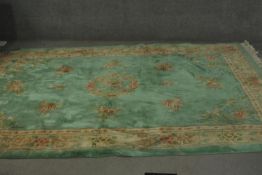 A Chinese green ground hand made carpet. L.310 W.210cm.