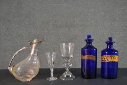 A collection of 19th century glass ware, including two Bristol blue apothecary bottles with stoppers