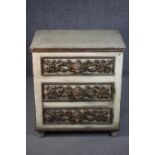 A cream painted chest of three long drawers, both sides with six panels, each panel with a