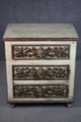 A cream painted chest of three long drawers, both sides with six panels, each panel with a
