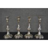 A set of four Victorian repousse design silver plated candlesticks, makers mark to base. H.27cm