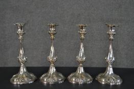 A set of four Victorian repousse design silver plated candlesticks, makers mark to base. H.27cm