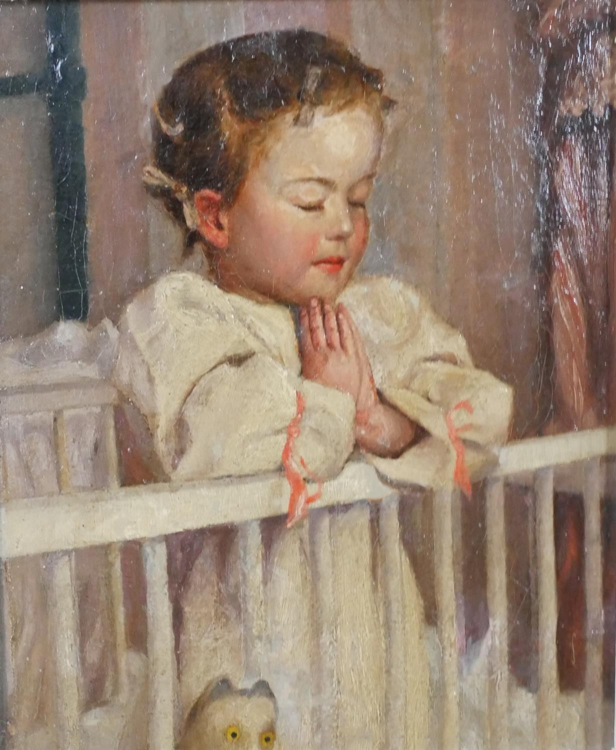 A carved framed oil on canvas of a child praying in her cot. Unsigned. H.47 W.43cm.
