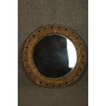 A circular mirror, with a moulded and pierced foliate frame. Dia. 47cm.