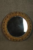 A circular mirror, with a moulded and pierced foliate frame. Dia. 47cm.