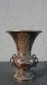 A Chinese 19th century bronze Archaic style vase with relief dragon and character design. H.19.5