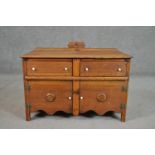 An early 20th century teak sideboard, with a gallery back over two short drawers and two cupboard