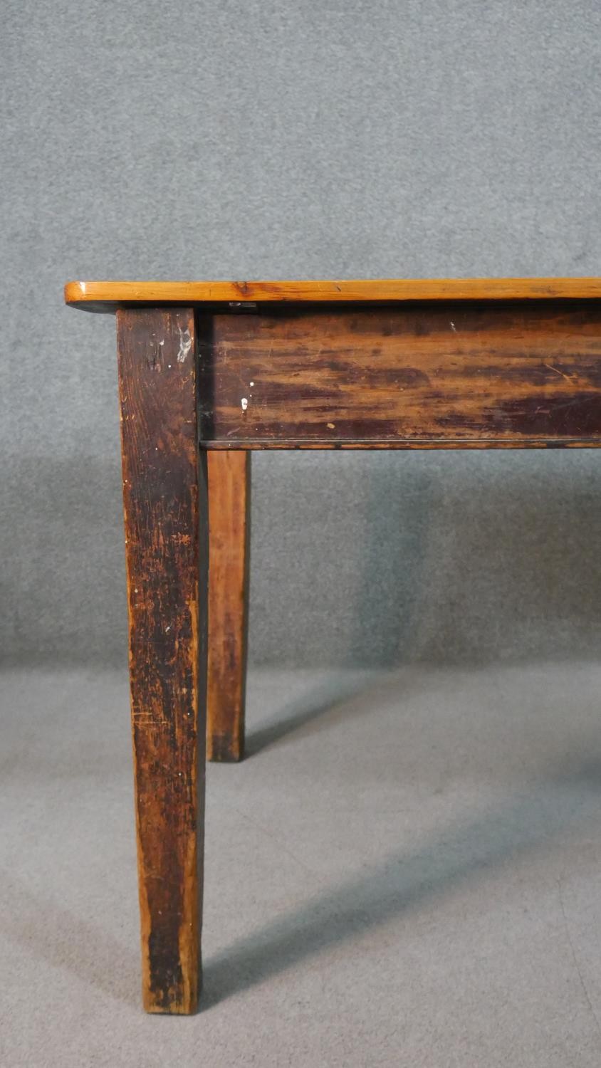 A C.1900 planked top kitchen table on distressed square section tapering supports. H.74 W.119 D.82cm - Image 4 of 8
