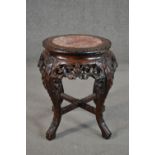 A 19th century Chinese carved hardwood jardiniere stand, the top with a circular marble insert,