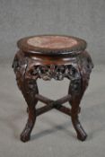 A 19th century Chinese carved hardwood jardiniere stand, the top with a circular marble insert,