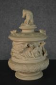 A 19th century French Sarreguemines bisque porcelain tobacco jar with relief wild boars and