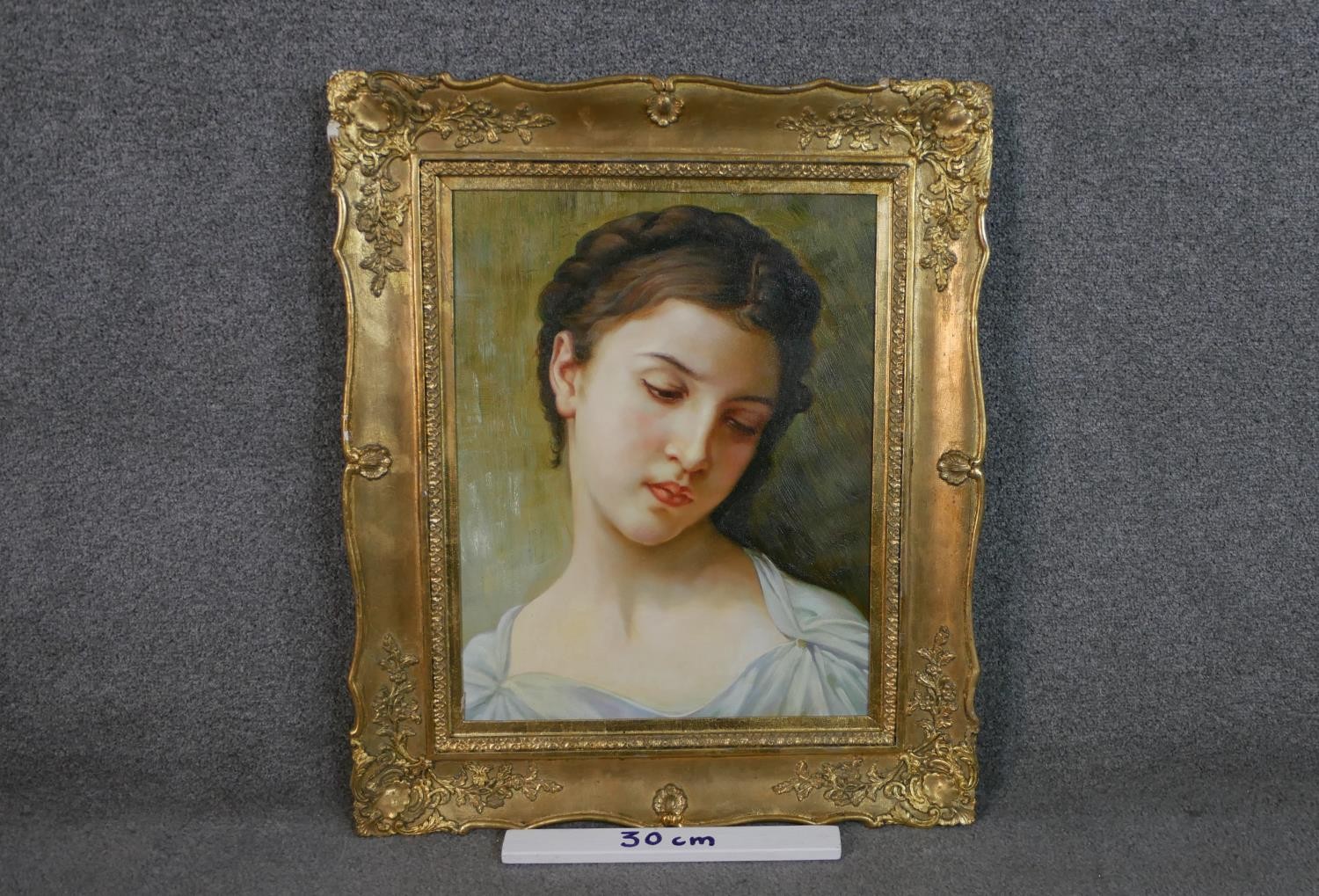 A gilt framed oil on canvas portrait of a young woman with plaited hair. H.69 W.57cm. - Image 3 of 6