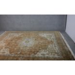 A hand made tan ground Indo-Heriz carpet. L.300 W.245cm