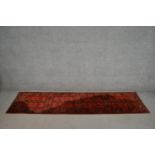 A hand made red ground Hachli motif runner. L.256 W.68cm