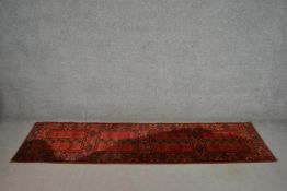 A hand made red ground Hachli motif runner. L.256 W.68cm