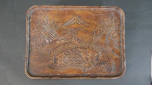 A Chinese early 20th century carved and stained tray decorated with a landscape scene with a