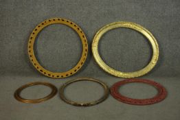 A collection of five circular and oval picture frames, some gilded, one red. H.60 W.50cm. (largest)