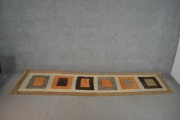 A hand made tan ground Indian Kelim runner with geometric design. L.317 W.72cm
