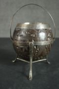 A carved 19th century coconut sugar bowl with white metal stand, rim and handle. H.13 W.12 D.12cm
