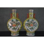 A pair of large late 19th - early 20th century Chinese Famille Rose moon flasks, one side