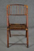 A folding bamboo chair, with a slatted back and seat.
