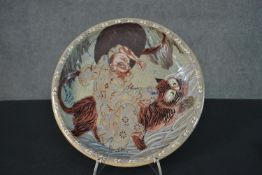 A Japanese 19th century Kutani ware bowl with an immortal riding a tiger, cloud motifs to the