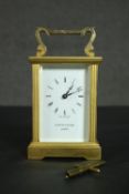 A gilt brass Mappin & Webb carriage clock with white enamel dial and fluted columns. With key. H.