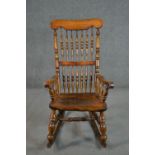 A rustic rocking chair, with turned spindle back, with elm bobbin turned arms, and an elm seat, on