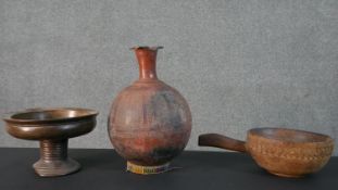 A collection of three African tribal vessels, including a terracotta vase with etched design, a