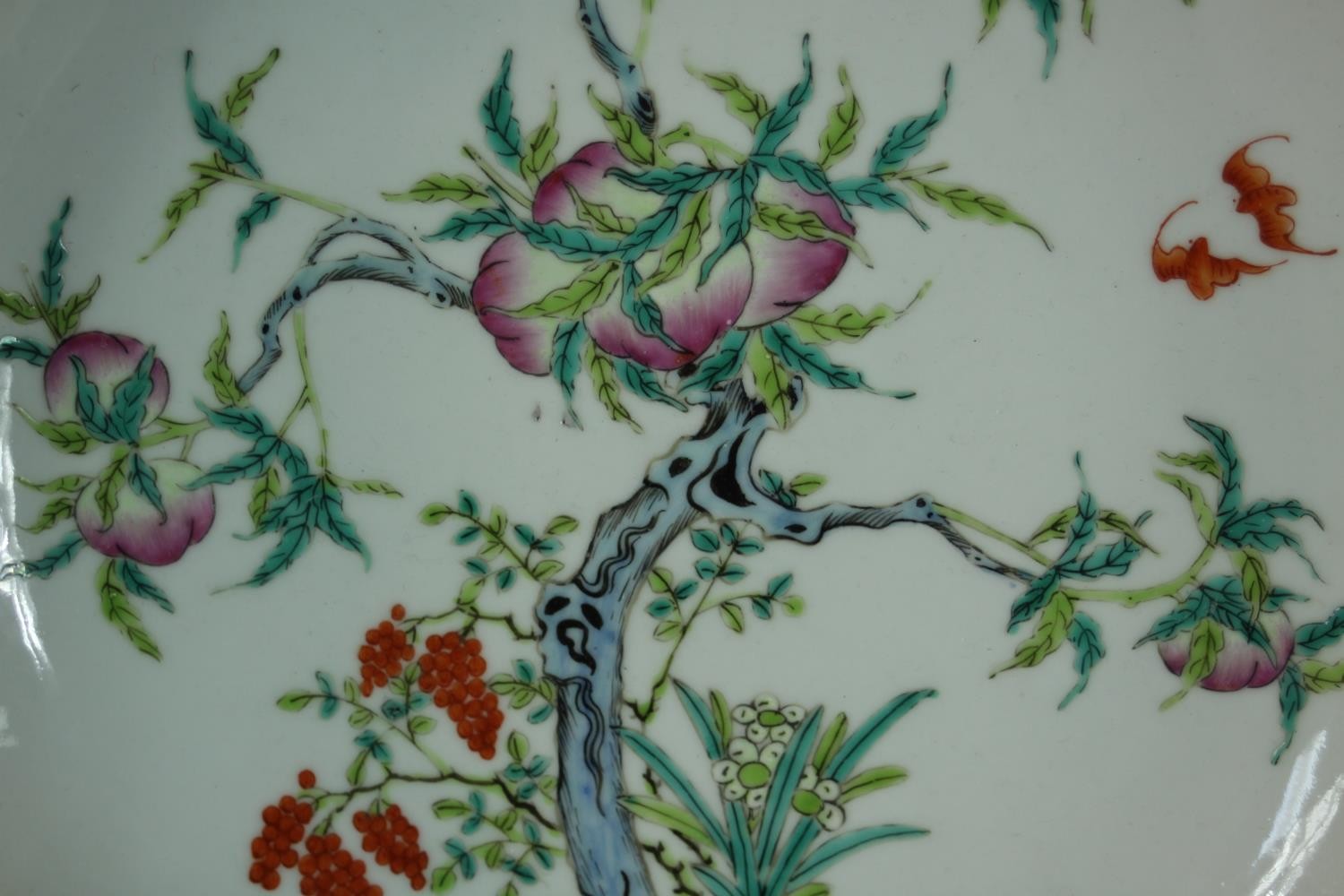 A Famille Rose Chinese porcelain nine peaches plate, decorated with lucky bats, grapes and a peach - Image 3 of 6