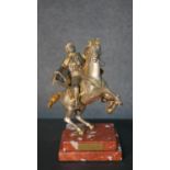 A gilt and silvered bronze of a man on horse back with turban and sword, indistinctly signed to