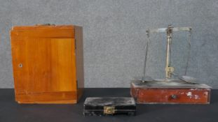 A set of early 20th century weighing scales with a set of brass weights along with a boxed