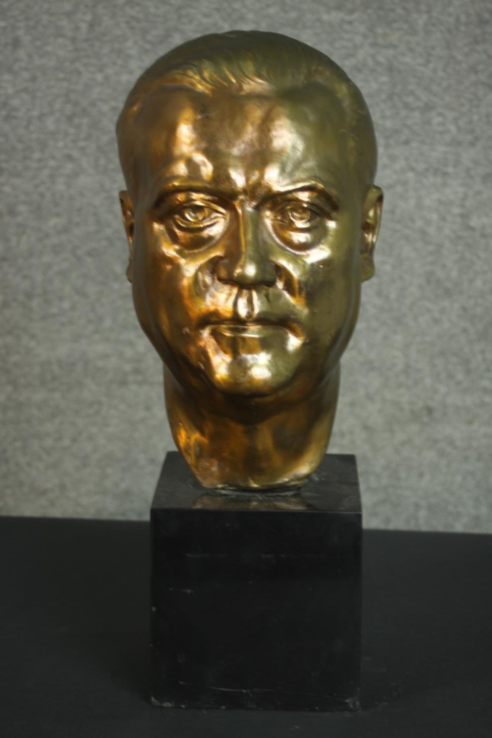 A 20th century bronze head of a gentleman, mounted on a black marble base. H.48 W.18 D.23cm.