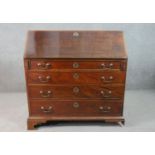 A George III mahogany bureau, the fall front opening to reveal a central cupboard door, drawers