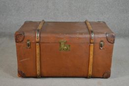 An early 20th century brown travel trunk, with wood bracing and brown leather corners. (locked) H.42