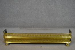 A George III brass fender, with two tiers of pierced brass vine design. (loose piece of brass