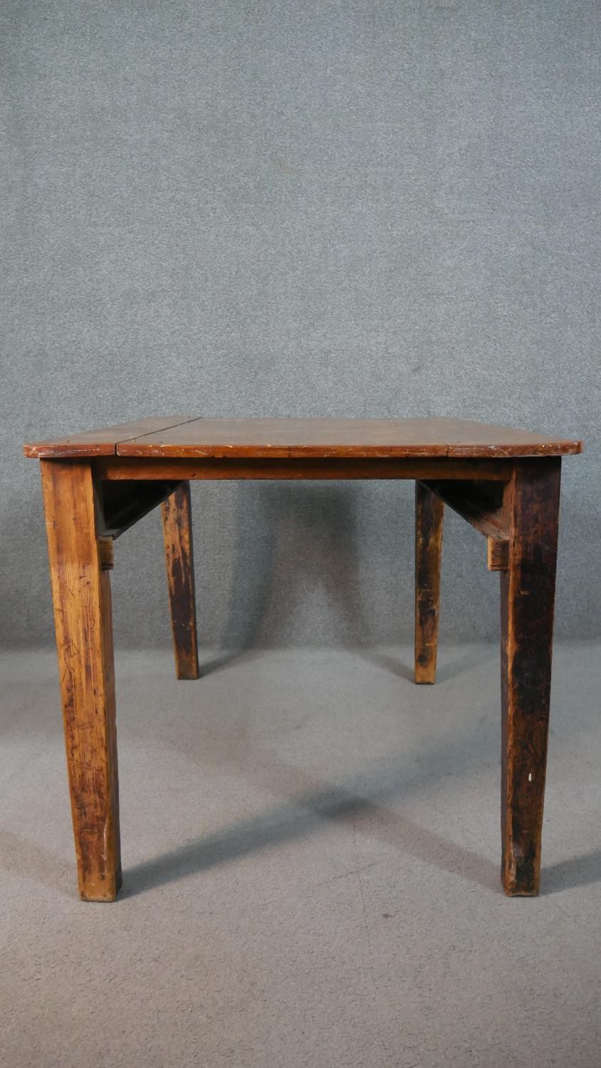 A C.1900 planked top kitchen table on distressed square section tapering supports. H.74 W.119 D.82cm - Image 8 of 8