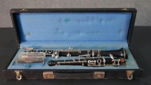 A cased Corton oboe with spare reeds.