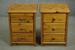 A pair of late 20th century pine bedside chests, of three drawers with knob handles. H.59 W.45. D.