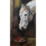 A framed oil on canvas of a horse feeding. Unsigned. H.38 W.33cm.