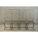 A set of four wrought iron folding garden dining chairs, with lattice back and seat.