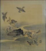 A 19th century framed and glazed Japanese ink on silk of two fighting birds mid flight while