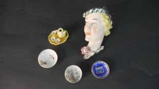 A collection of porcelain, including an Art Deco relief wall plaque of a blonde female, impressed