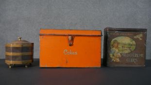 Two vintage tins and a 19th century copper and brass tea caddy. The orange painted cake tin with