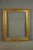 A large 20th century giltwood and resin picture frame with floral and foliate motifs. H.130 W.100cm.