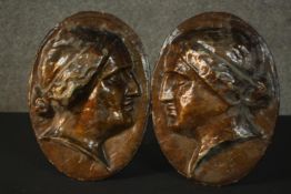 Two 19th century papier mache classical style bust relief wall plaques. H.21 W.23cm each.